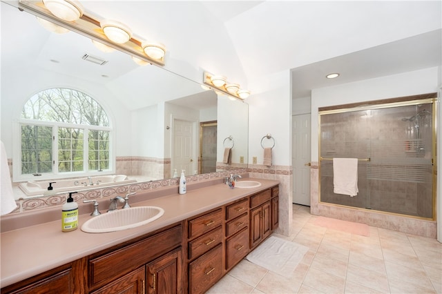 bathroom featuring vanity with extensive cabinet space, dual sinks, tile floors, independent shower and bath, and lofted ceiling