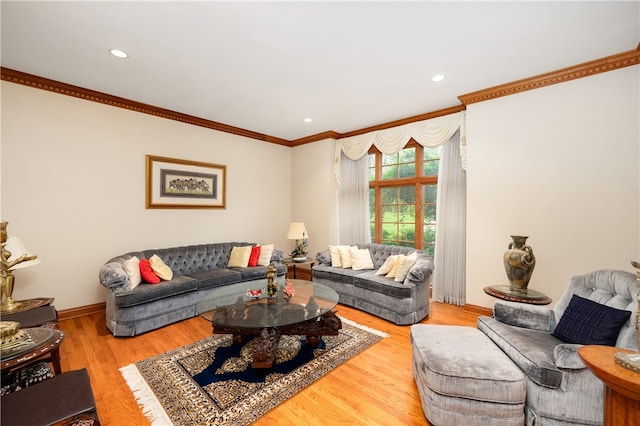 living room with light hardwood / wood-style floors and crown molding