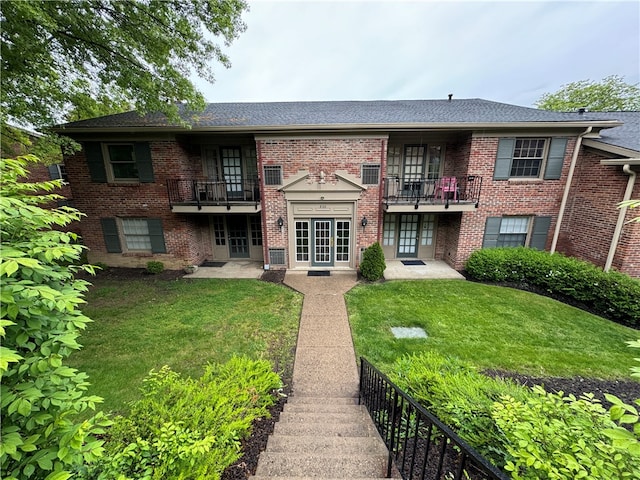 exterior space with a yard and a balcony