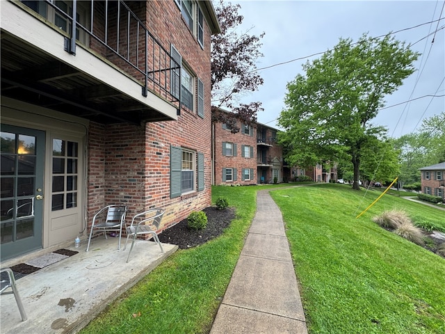 view of yard with a patio area and a balcony