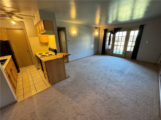 kitchen with white electric range oven, ceiling fan, and light tile flooring