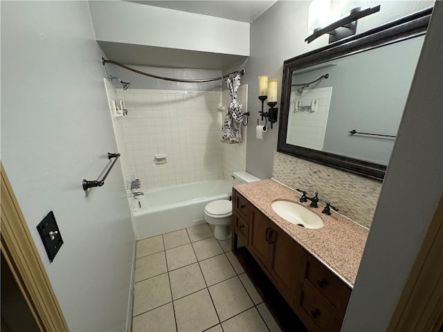 full bathroom featuring tile floors, vanity, toilet, and tiled shower / bath combo