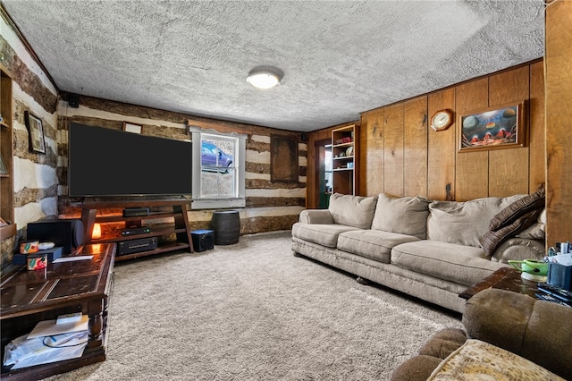 living room featuring wood walls, carpet, and a textured ceiling