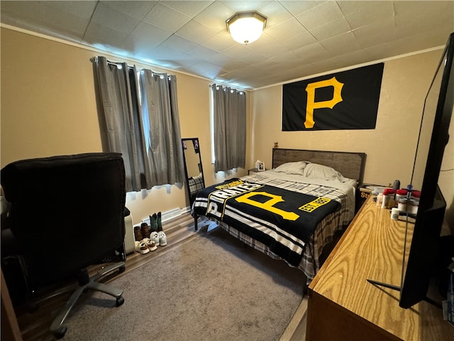 carpeted bedroom with ornamental molding