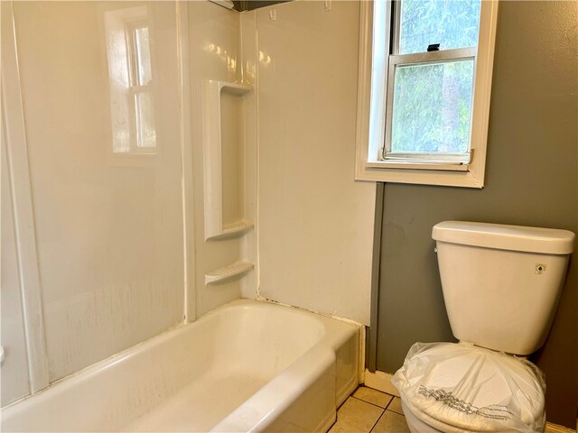 bathroom featuring shower / tub combination, tile patterned flooring, and toilet