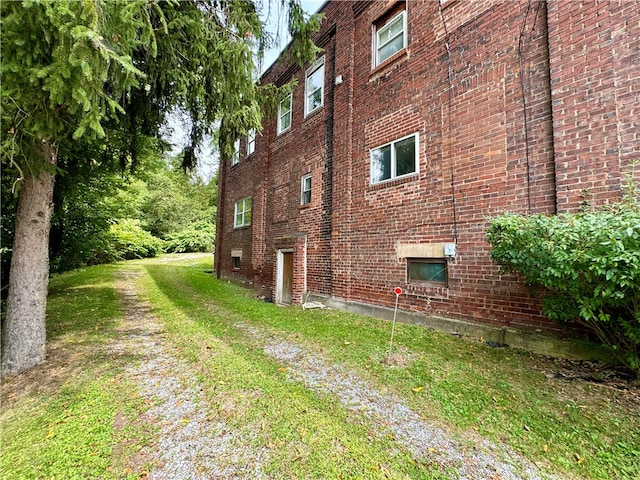 view of property exterior featuring a lawn