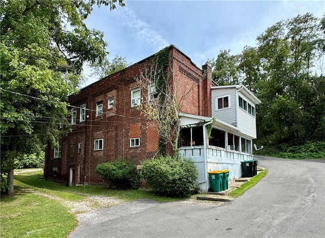 view of property exterior with a yard