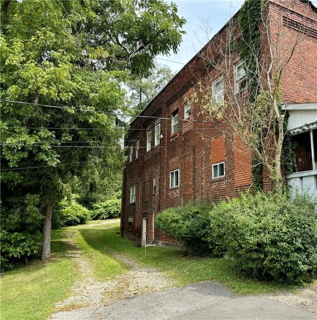 view of side of home featuring a lawn