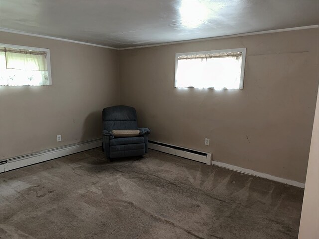 unfurnished room with plenty of natural light, carpet floors, and a baseboard radiator