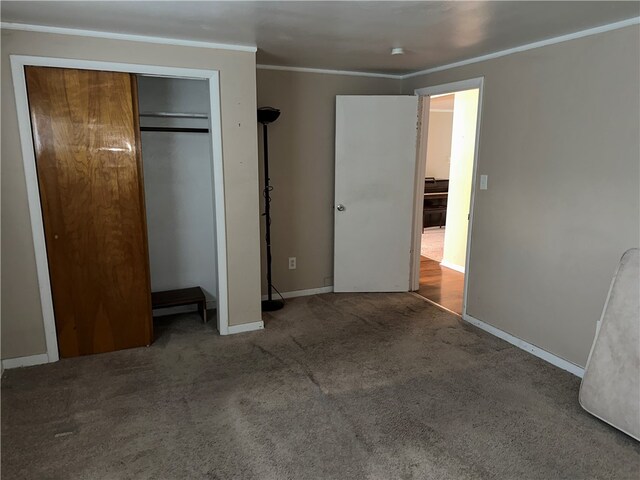 unfurnished bedroom featuring a closet, carpet, and crown molding