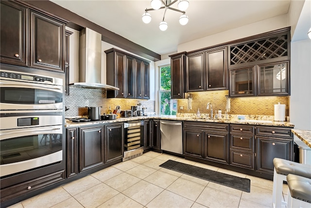 kitchen with wine cooler, sink, wall chimney range hood, backsplash, and dark brown cabinets