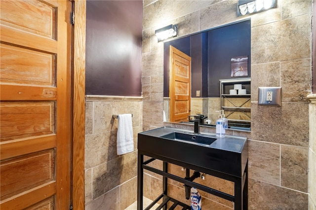 bathroom with tile walls and sink