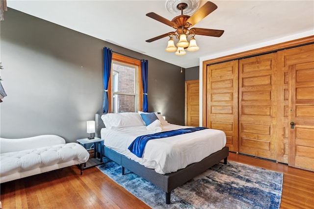 bedroom featuring hardwood / wood-style floors, a closet, and ceiling fan