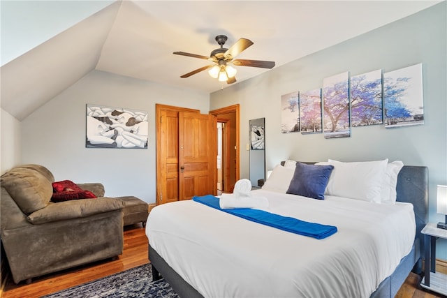 bedroom with vaulted ceiling, ceiling fan, and hardwood / wood-style flooring