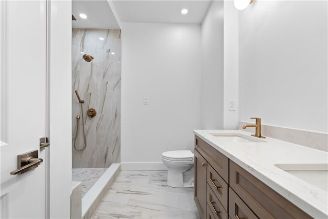 bathroom featuring dual bowl vanity, tiled shower, tile flooring, and toilet