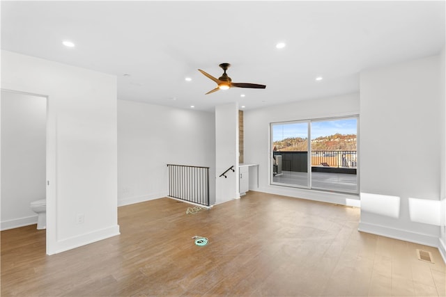 unfurnished room featuring light hardwood / wood-style flooring and ceiling fan