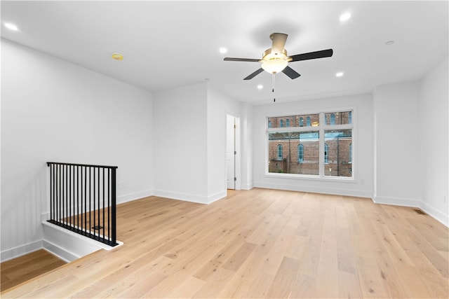 unfurnished room featuring ceiling fan and light wood-type flooring