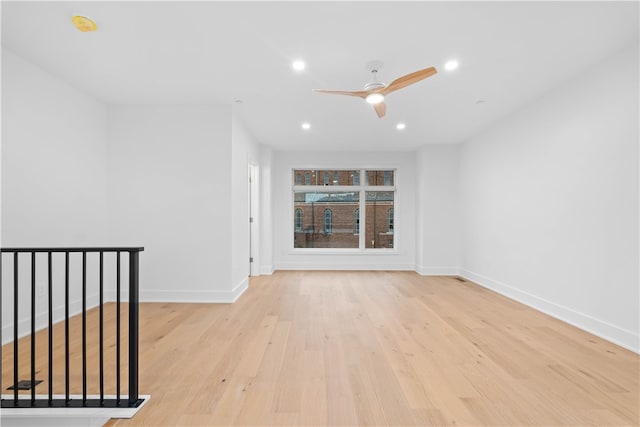 unfurnished room featuring ceiling fan and light wood-type flooring