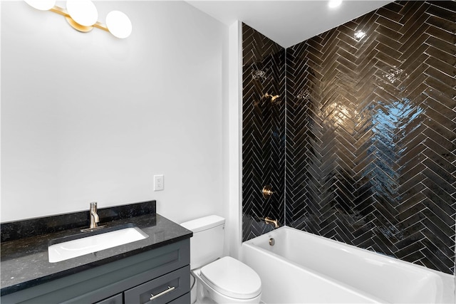 full bathroom featuring tiled shower / bath combo, vanity, and toilet