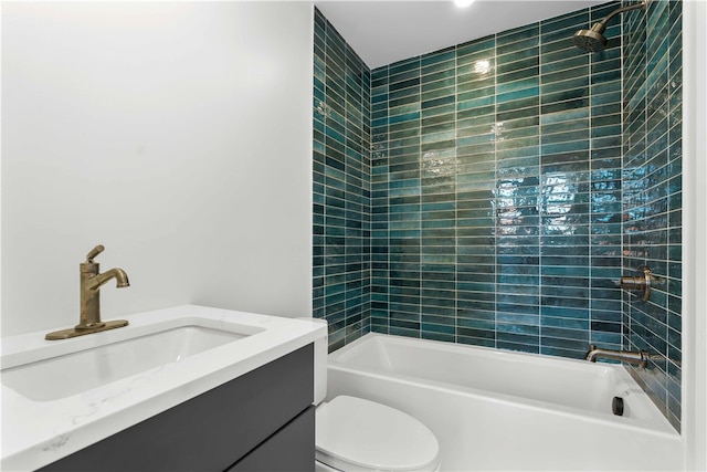 full bathroom with tiled shower / bath combo, vanity, and toilet