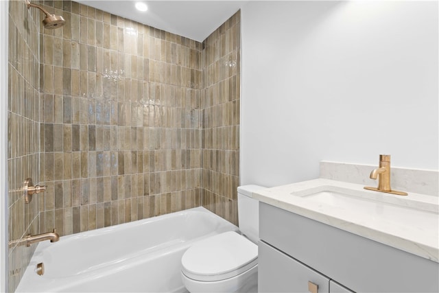 full bathroom featuring tiled shower / bath combo, vanity, and toilet