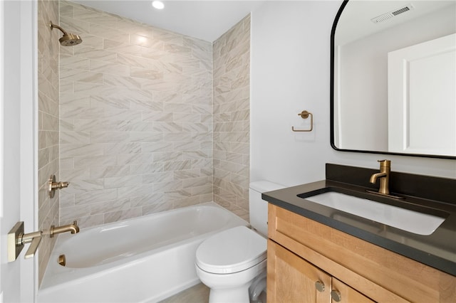 full bathroom with vanity, tiled shower / bath combo, and toilet