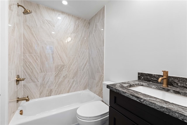 full bathroom featuring vanity, toilet, and tiled shower / bath