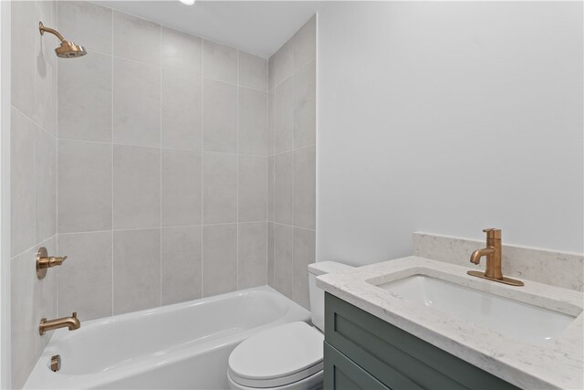 full bathroom with tiled shower / bath combo, toilet, and vanity