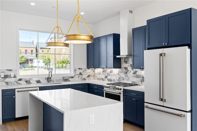 kitchen with high quality appliances, light hardwood / wood-style floors, a center island, and blue cabinetry