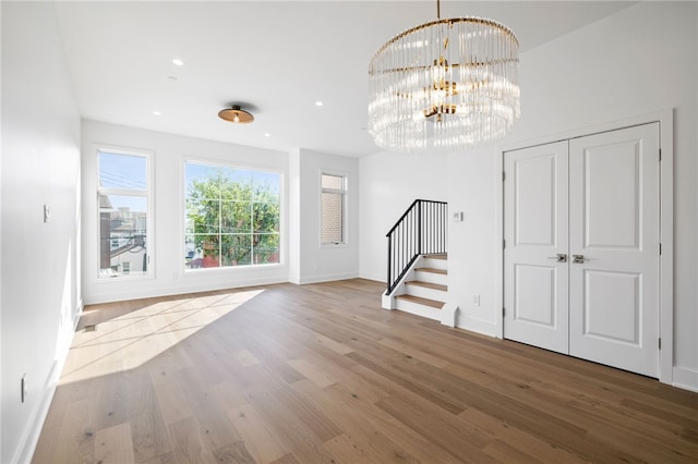 interior space featuring wood-type flooring and a chandelier