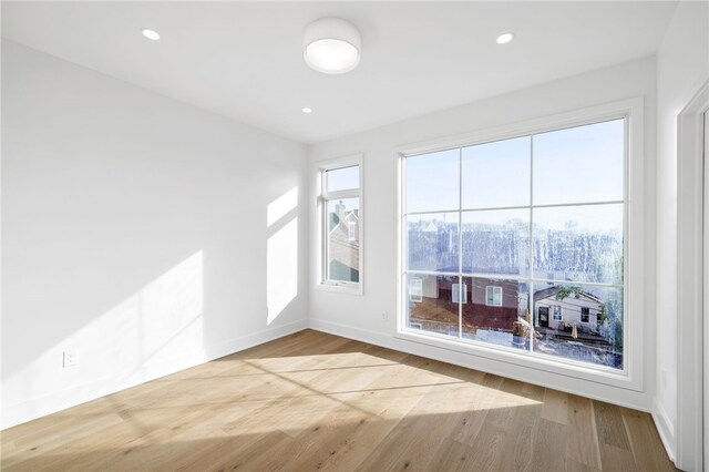 unfurnished room featuring light hardwood / wood-style flooring and plenty of natural light