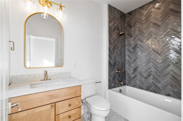 full bathroom featuring tiled shower / bath, toilet, and vanity