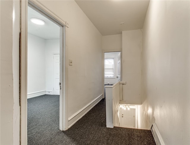 hallway with dark colored carpet