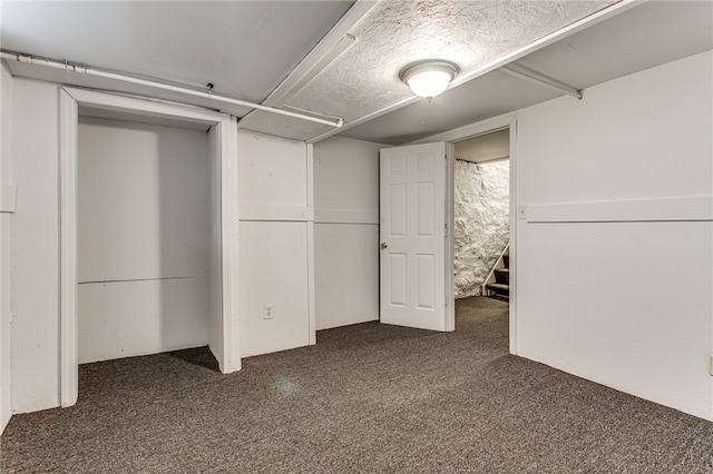 basement with dark carpet