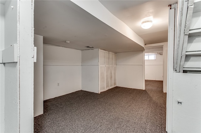 basement with dark carpet