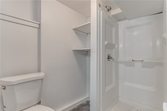 bathroom featuring a shower and toilet