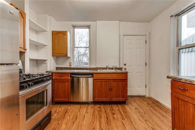 kitchen featuring sink, a healthy amount of sunlight, light hardwood / wood-style flooring, and appliances with stainless steel finishes