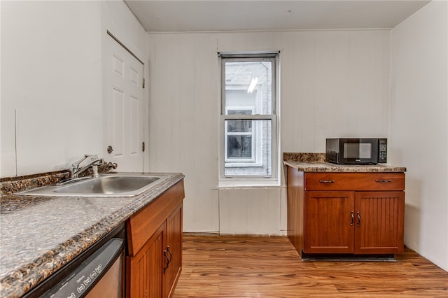 kitchen with dishwasher, sink, and light hardwood / wood-style flooring