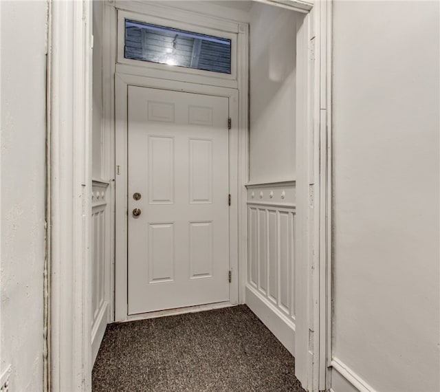 doorway to outside with dark carpet