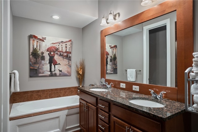 bathroom featuring a bath and dual vanity