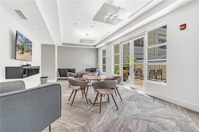 interior space with french doors and a tray ceiling