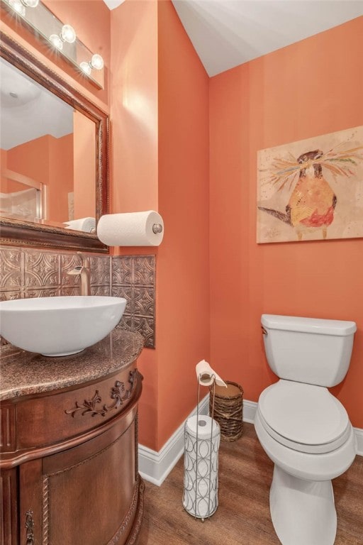 bathroom featuring hardwood / wood-style floors, vanity, and toilet