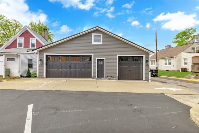 view of front of home featuring a garage and central AC unit