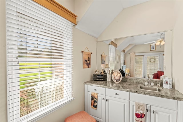 interior space with lofted ceiling, vanity, and plenty of natural light