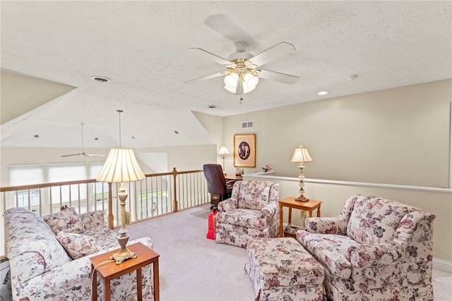 sitting room with ceiling fan, a textured ceiling, light carpet, and vaulted ceiling