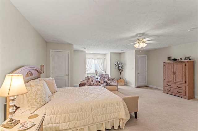 carpeted bedroom featuring a textured ceiling and ceiling fan