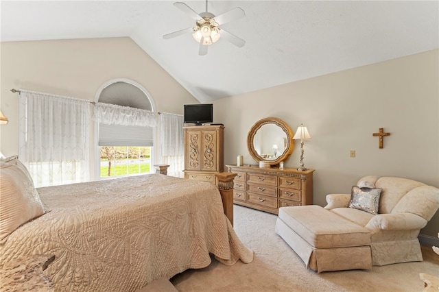 bedroom featuring vaulted ceiling, light carpet, and ceiling fan