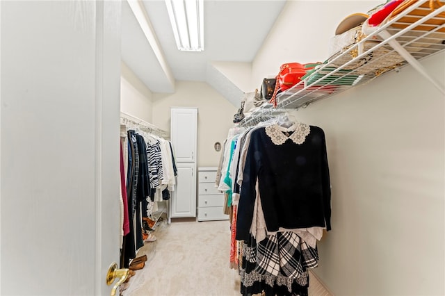 walk in closet featuring light colored carpet