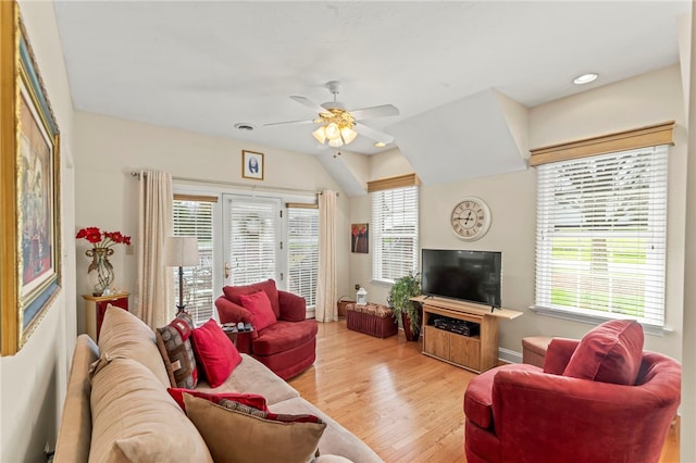 living room featuring a healthy amount of sunlight, light hardwood / wood-style floors, and ceiling fan