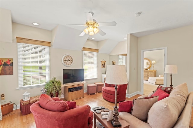 living room with light hardwood / wood-style floors and ceiling fan